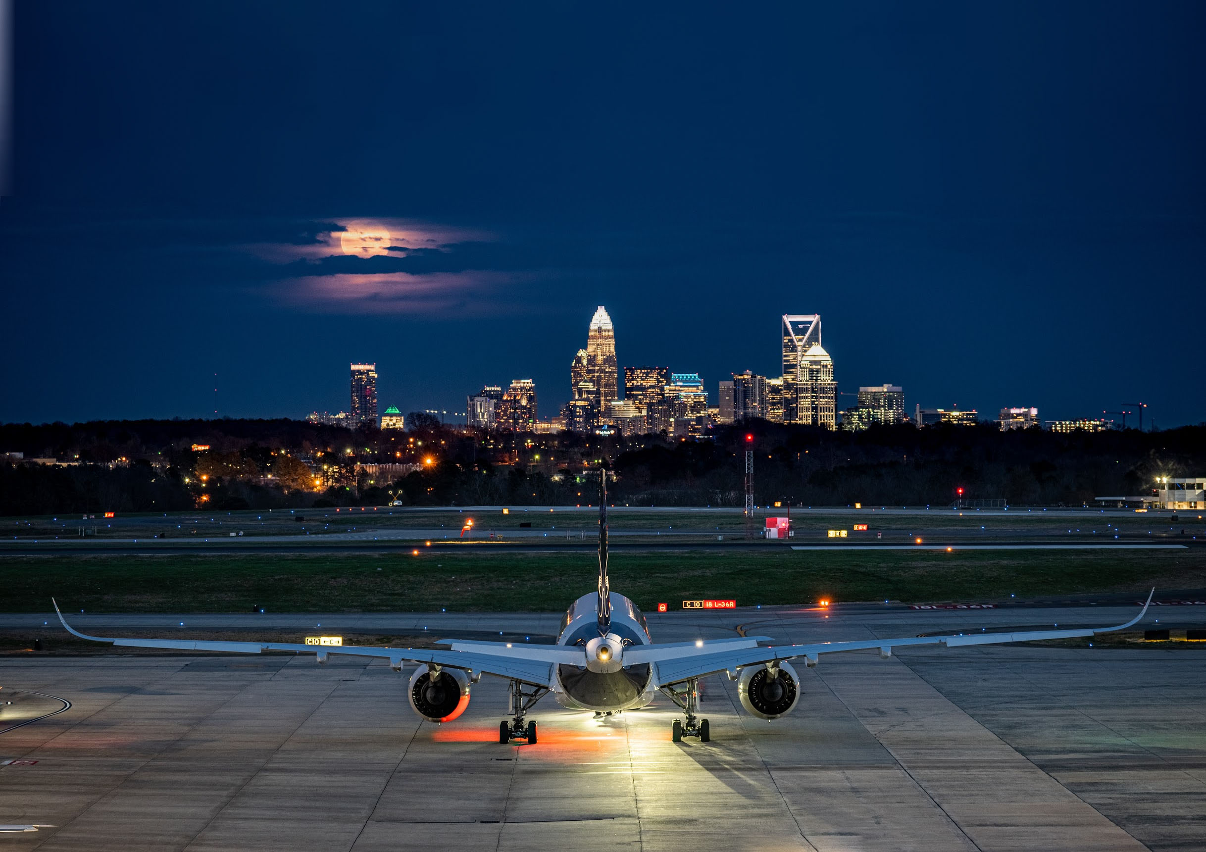 Charlotte Douglas International Airport (CLT) at night - view towards city skyline, rich with commercial real estate opportunities.
