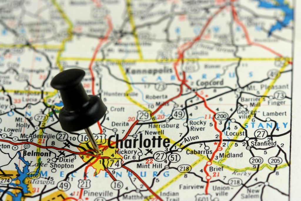North Carolina map with a push pin in Charlotte: leave your mark in Charlotte's commercial real estate