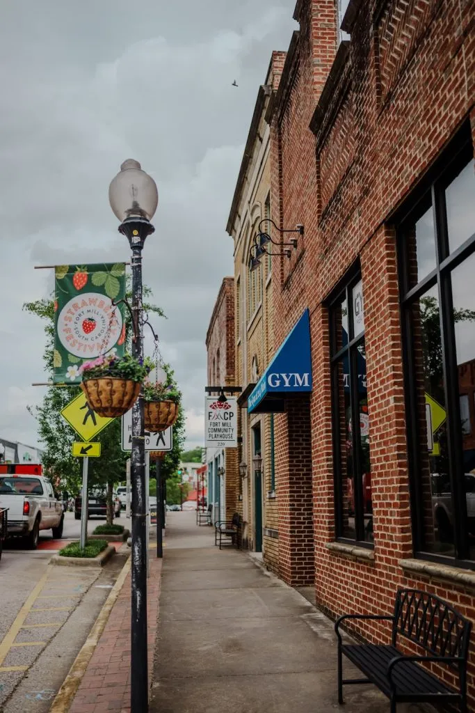sidewalk view of fort mill streetlights and strawberry festival banners
