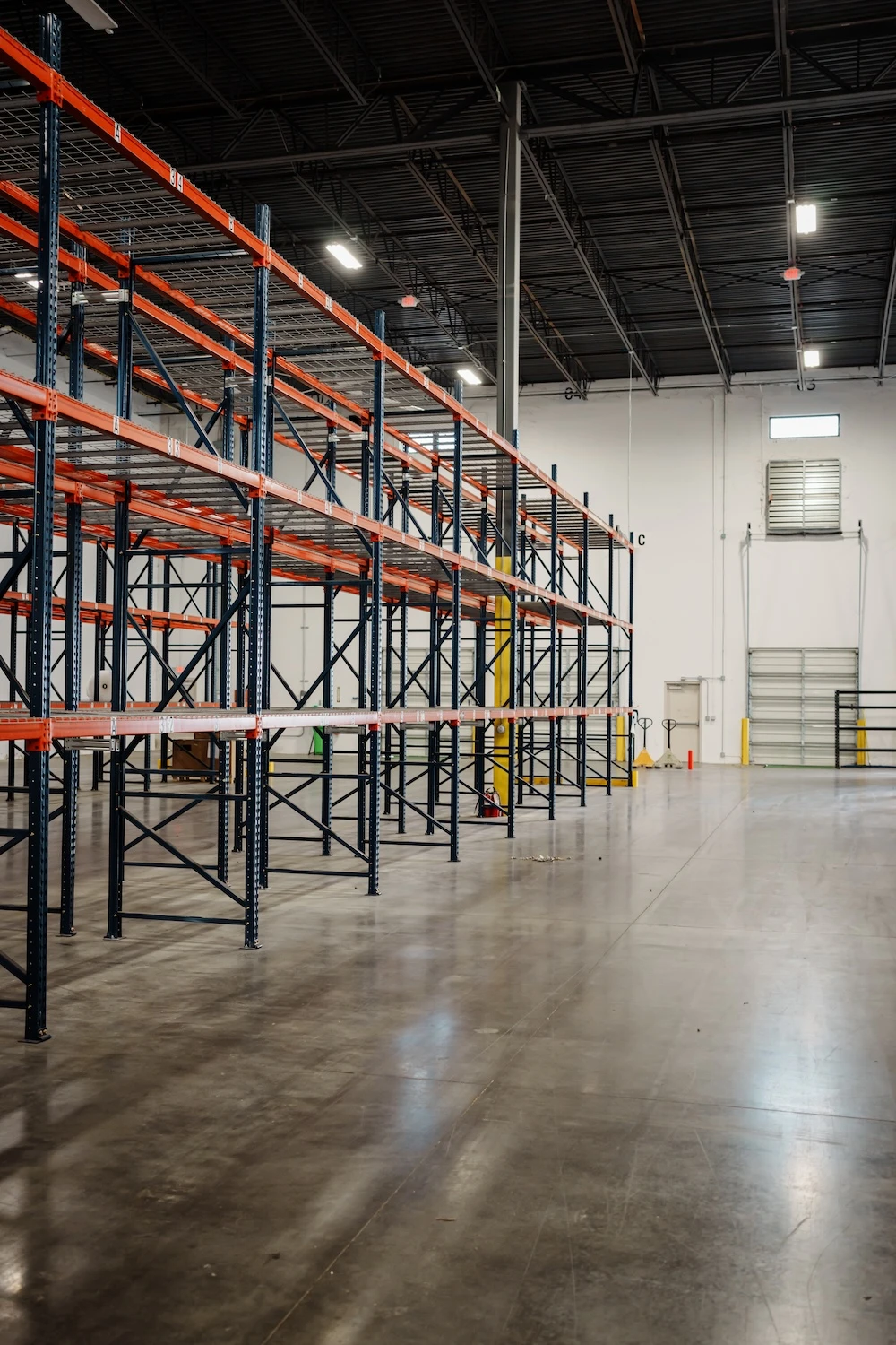 empty shelving inside warehouse ready for more