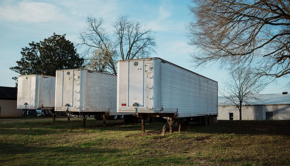 trailers parked on grassy lot industrial outdoor storage space